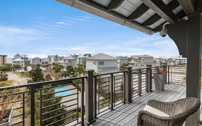 a balcony with two chairs and a view of the ocean at Heaven on Pointe in Santa Rosa Beach