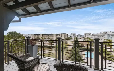 a balcony with chairs and a view of the water at Heaven on Pointe in Santa Rosa Beach