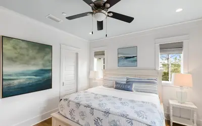 a bedroom with a bed with a ceiling fan at Heaven on Pointe in Santa Rosa Beach