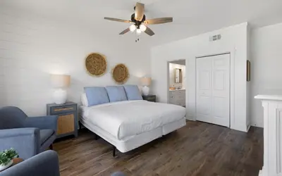 a bedroom with a bed and a ceiling fan at High Pointe Unit 2-223 in Rosemary Beach