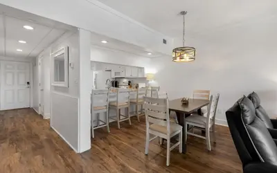 a kitchen and dining room with a table and chairs at High Pointe Unit 2-223 in Rosemary Beach