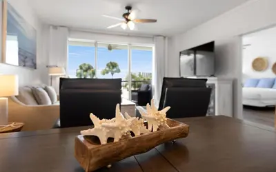 a dining room with a table with starfish on it at High Pointe Unit 2-223 in Rosemary Beach