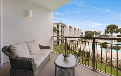 a balcony with a couch and a table and a view of the beach at High Pointe Unit 2-223 in Rosemary Beach