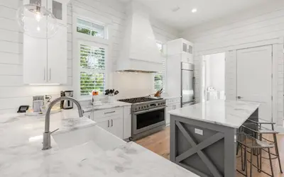 a white kitchen with a sink and a stove at Keepin It Reel in Santa Rosa Beach