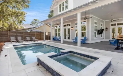 an exterior view of a house with a swimming pool at Keepin It Reel in Santa Rosa Beach