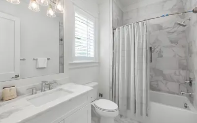 a white bathroom with a sink and a toilet at Keepin It Reel in Santa Rosa Beach