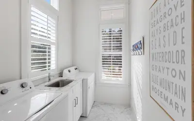 a white kitchen with a sink and a window at Keepin It Reel in Santa Rosa Beach