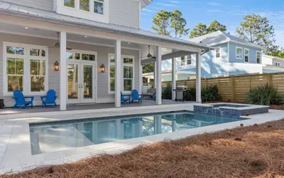 a house with a swimming pool in front of a house at Keepin It Reel in Santa Rosa Beach