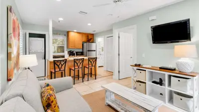 a living room with a couch and a tv at Lemon Drop House in Seacrest