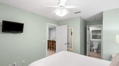 a bedroom with a bed and a ceiling fan at Lemon Drop House in Seacrest