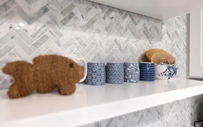 a shelf with blue and white cups and a bear figurine at LakeTide Retreat in Santa Rosa Beach