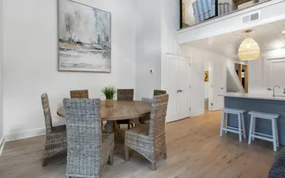 a dining room with a wooden table and chairs at LakeTide Retreat in Santa Rosa Beach