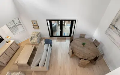 a living room with a couch and a table at LakeTide Retreat in Santa Rosa Beach