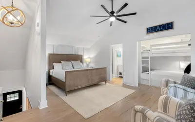a bedroom with a bed and a living room at LakeTide Retreat in Santa Rosa Beach