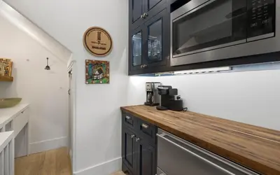 a kitchen with a wooden counter top with a microwave at Maison Moon in Santa Rosa Beach