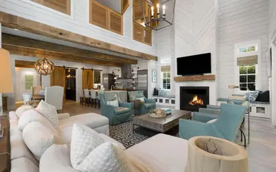 a living room with white furniture and a fireplace at Maison Moon in Santa Rosa Beach