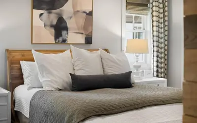 a bedroom with a bed with white pillows at Maison Moon in Santa Rosa Beach