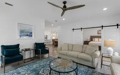 a living room with a couch and chairs and a bed at Occasionally Luxe in Seacrest