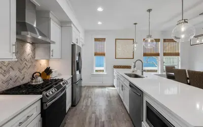 a kitchen with a sink and a stove top oven at Occasionally Luxe in Seacrest