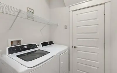 a white laundry room with a washing machine at Once Upon A Tide in Inlet Beach