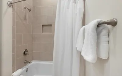 a bathroom with a shower with a white towel at Once Upon A Tide in Inlet Beach