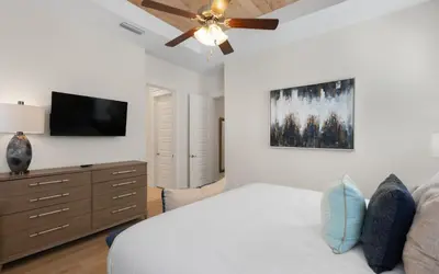 a bedroom with a bed and a ceiling fan at Once Upon A Tide in Inlet Beach