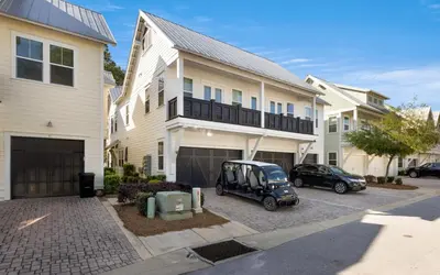 a golf cart parked in front of a house at Once Upon A Tide in Inlet Beach