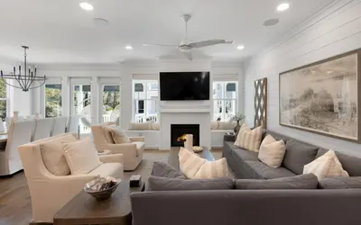 a living room with a couch and a fireplace at Out of Office in Santa Rosa Beach