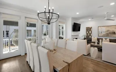 a dining room and living room with a table and chairs at Out of Office in Santa Rosa Beach
