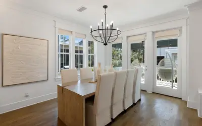 a dining room with a table and chairs at Out of Office in Santa Rosa Beach