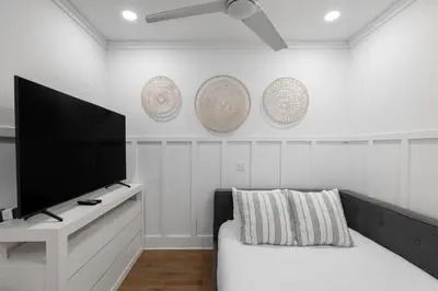 a living room with a flat screen tv and a couch at Out of Office in Santa Rosa Beach