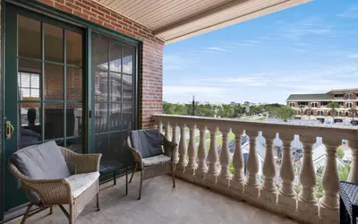 a balcony with chairs and a view of the city at Peanuts Place in Seacrest