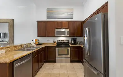 a kitchen with wooden cabinets and stainless steel appliances at Peanuts Place in Seacrest