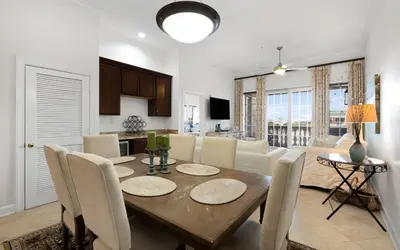 a dining room and living room with a table and chairs at Peanuts Place in Seacrest