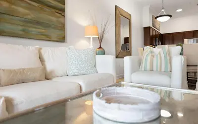 a living room with a white couch and a table at Peanuts Place in Seacrest
