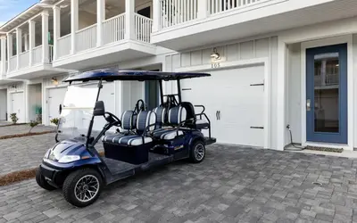 a golf cart parked in front of a garage at Saltwater Song in Santa Rosa Beach