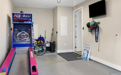a room with a video game machine in a room at Saltwater Song in Santa Rosa Beach