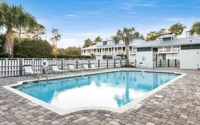 a swimming pool in front of a house at Saltwater Song in Santa Rosa Beach