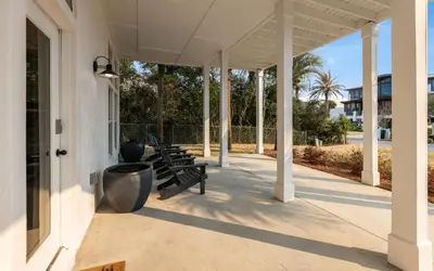 a porch with benches on the side of a building at Sea n Stars in Seacrest