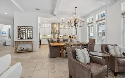a dining room and living room with a table and chairs at Sundance in Inlet Beach
