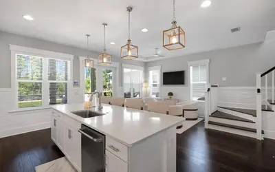 a kitchen with white cabinets and a kitchen island at Surf Sanctuary in Santa Rosa Beach