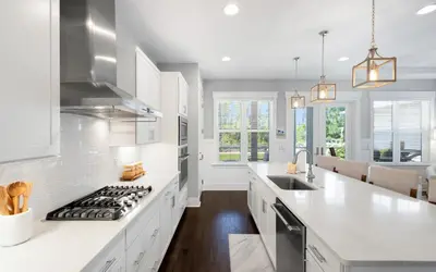 a kitchen with white cabinets and a stove top oven at Surf Sanctuary in Santa Rosa Beach