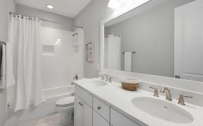 a white bathroom with two sinks and a toilet at Surf Sanctuary in Santa Rosa Beach