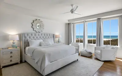 a white bedroom with a bed and a view of the ocean at The Crossings at Watersound Beach C214 in Inlet Beach