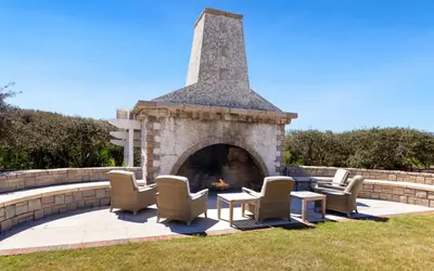 a group of chairs and a fireplace in a yard at The Crossings at Watersound Beach C214 in Inlet Beach
