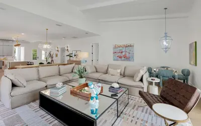 a living room with a couch and a table at Tickled Pink in Santa Rosa Beach