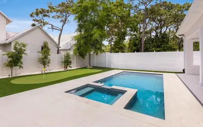 a swimming pool in the backyard of a house at Tickled Pink in Santa Rosa Beach