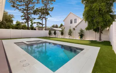 a swimming pool in the yard of a house at Tickled Pink in Santa Rosa Beach