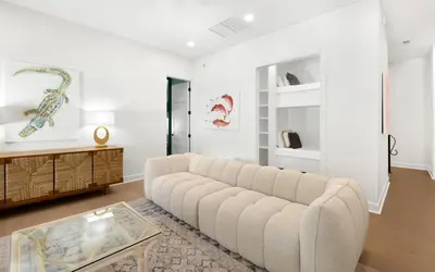 a living room with a couch and a table at Tickled Pink in Santa Rosa Beach