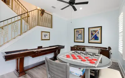 a room with a piano and a table with a cake on it at Villa Dolce in Santa Rosa Beach